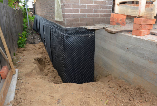 Happy homeowners after waterproofing job in Waldron
